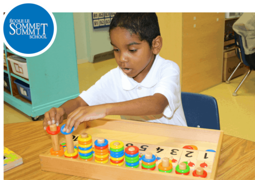 Summit School Services: a child plays with a toy that teaches about numbers